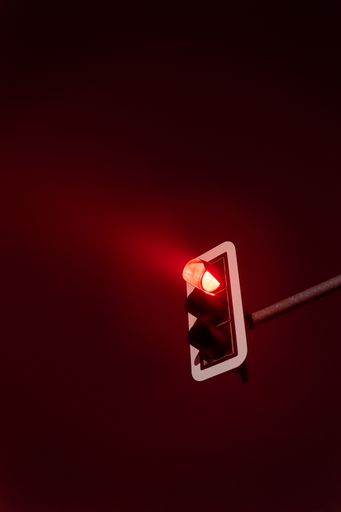 A vertical shot of traffic lights at night