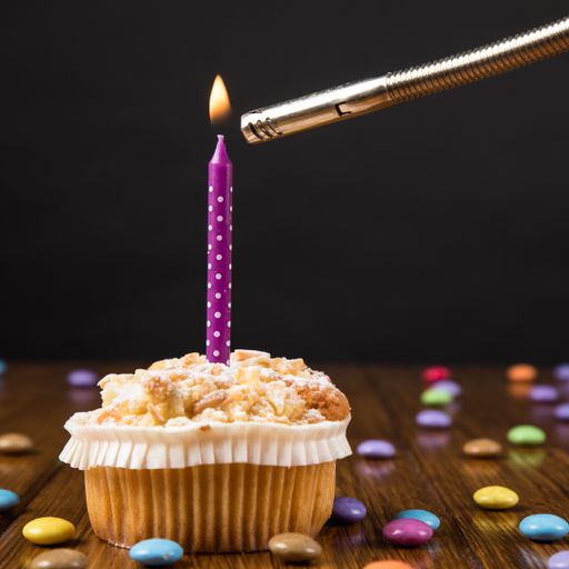 A closeup shot of a cupcake with a burning candle and colorful candies
