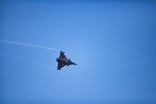 A scenic view of a Royal Belgian Air Force airplane flying in the blue sky