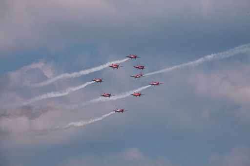 A scenic view of Royal Belgian Air Force airplanes flying in the cloudy sky