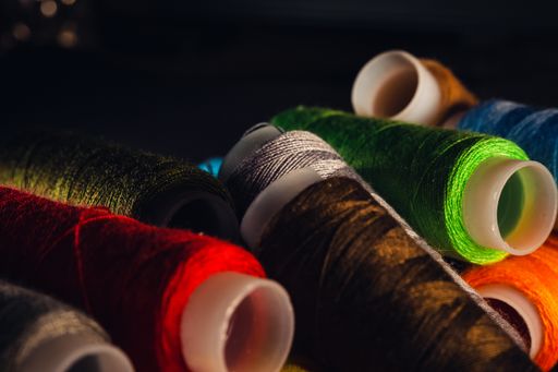 A selective focus shot of colorful rope rolls for sewing
