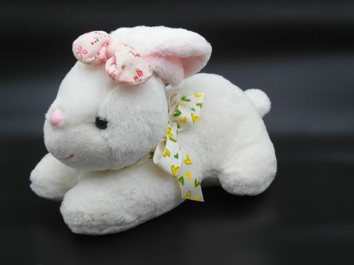 The close-up shot of the white bunny toy