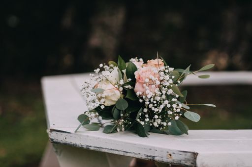 A close-up shot of a flower bouquet on the white table.
