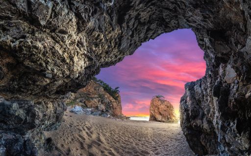 A "False" cave in the sunset in costa brava Cala Illa Roja. Amazing wallpaper