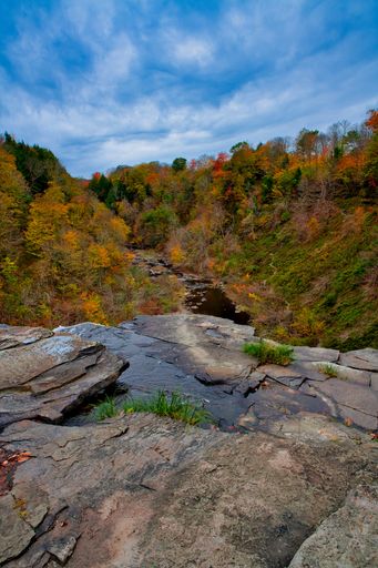 A vertical shot of the Salmon River Falls in autumn in Orwell, New York