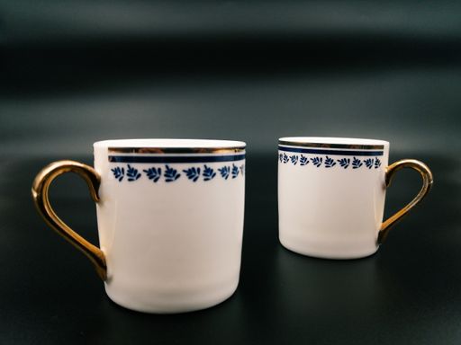 A closeup shot of porcelain cups isolated on a gray background
