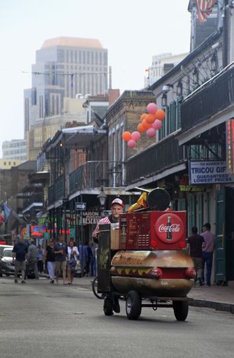 New Orleans, USA - 12 Jan 2020: A hot dog vendor pushes his cart down a street in the French Quarter of New Orleans.