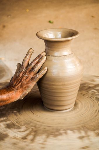 A vertical shot of hand doing clay pot in Jaipur, Rajasthan, India