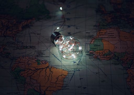 A lightbulb on the world map, the concept of tourism and travel