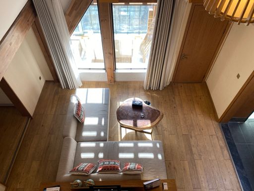 A high angle shot of a lounge room with a couch and a coffee table