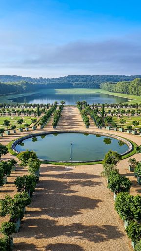 A Beautiful shot of green plants and grass in Gardens of Versailles under the sun
