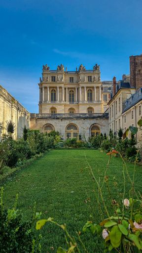 A Beautiful shot of green plants and grass in Gardens of Versailles under the sun