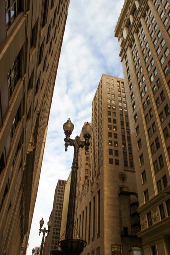A low angle shot of the old tall buildings in downtown Chicago
