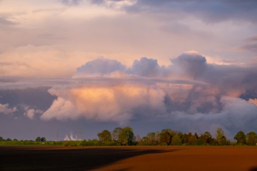 The massive stormy clouds over the agricultural field