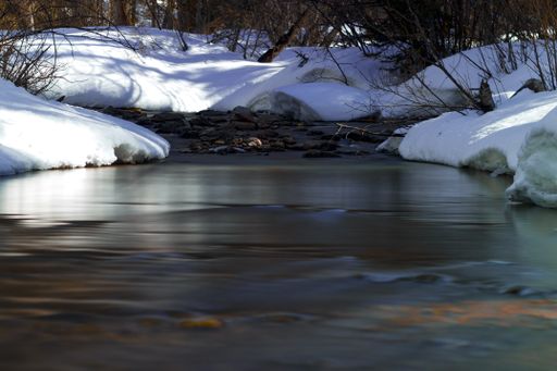 A cold river in a snowy field