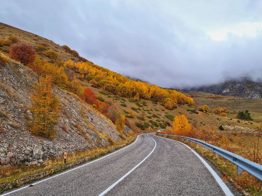 The fog slowly descending from the mountain and reaching to the road. Great for background