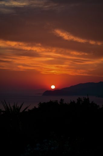 A beautiful view of a landscape with hills at sunset
