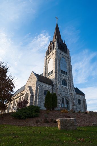 A low angle shot of Guardian Angels Church on a blue sky on a sunny day, Orillia, Ontario, Canada