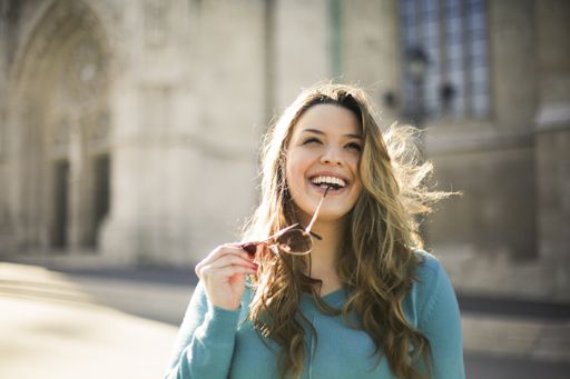 A closeup portrait of a pretty smiling Hispanic girl on the street