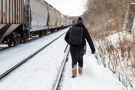 A shot of a man walking on the railways in winter
