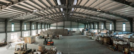 A wide shot of a warehouse with forklifts