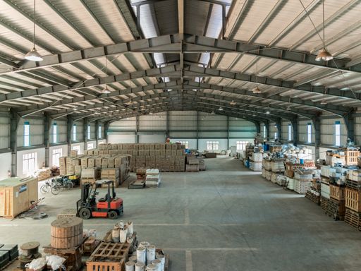 An interior shot of a warehouse with forklifts