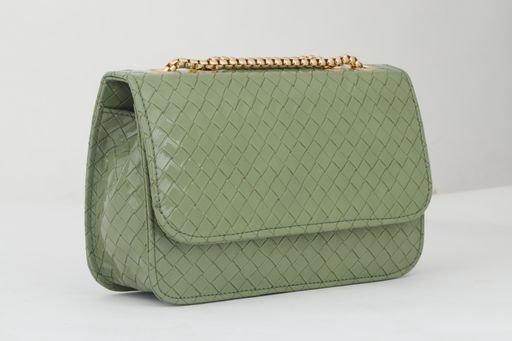 A closeup shot of a fashionable green leather bag with a golden chain isolated on the white background