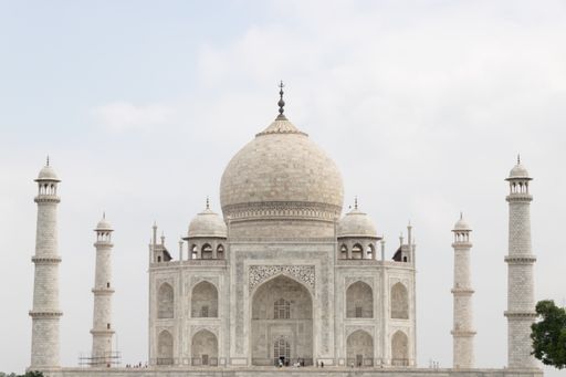 A beautiful view of the famous Taj Mahal against a light blue sky