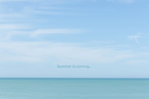 A landscape of the sea under a blue sky with a [Summer is coming...] text on it - perfect for wallpapers and backgrounds