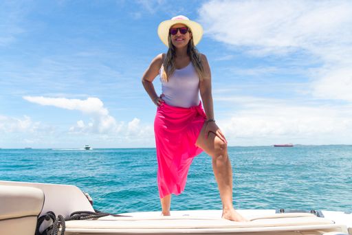 A woman on top of a boat against the sea
