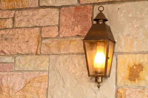 A closeup shot of a vintage lamp on the wall