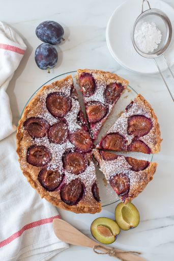 A vertical shot of a delicious pie baked with plums in a kitchen