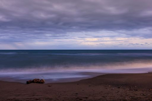 A beautiful shot of a seascape under the cloudy skies during sunrise