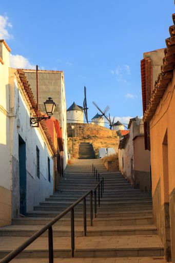 Traditional Spanish windmills seen from the village of Consuegra, in the La Mancha region of Spain at sunset