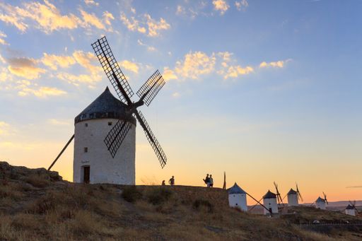 Traditional Spanish windmills near Consuegra, in the La Mancha regionof Spain with a view over the beautiful meseta highlands at sunset