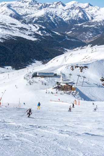 A vertical shot of people skiing in the Pyrenees at the Grandvalira ski resort, Andorra