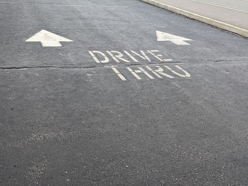 A closeup shot of a drive thru sign on the ground