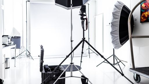 A beautiful shot of a photography studio with white lights and background
