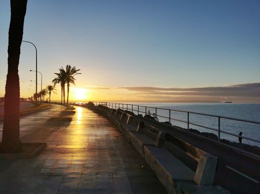 A path along the Mediterranean sea at sunset in Palma de Mallorca, Balearic Islands, Spain