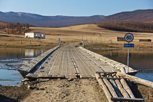 A long wooden bridge over a lake in Northern Mongolia
