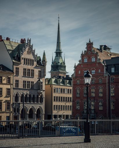 A beautiful view of the German Church in Stockholm, Sweden behind high urban buildings