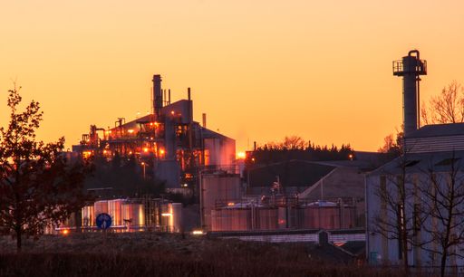 Factory surround with tanks and chimneys at a beautiful sunset. High quality photo