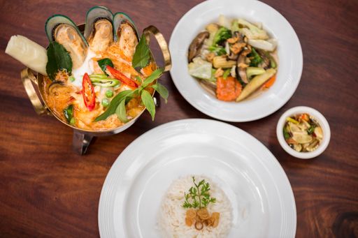 An overhead shot of a dish with clam near rice with a blurred background