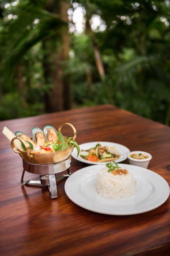 A vertical shot of different dishes near each other on a wooden table with a blurred background