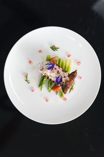 An overhead vertical shot of a dish with vegetables on a white plate