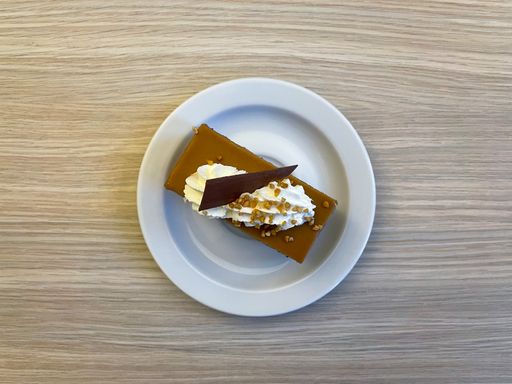 A top view of a Toffee cake on a white plate