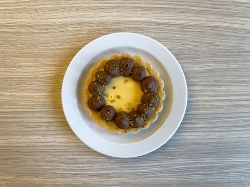 A closeup of a tartlet with passion fruit cream.