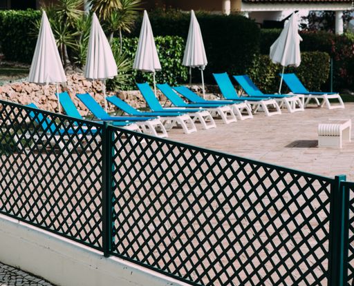 A beautiful shot of a bunch of chaise lounges near a pool