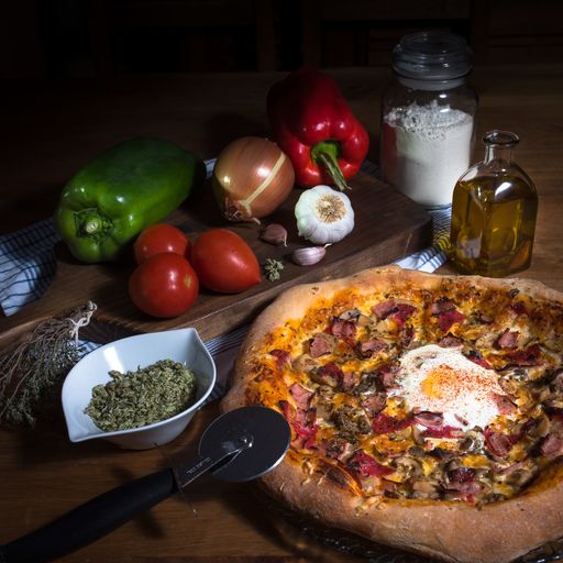 A closeup shot delicious tasty pizza and vegetables on a wooden table