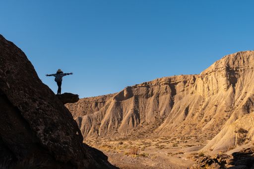 A young woman climbing along the desert of Tabernas in Almeria province in Andalusia